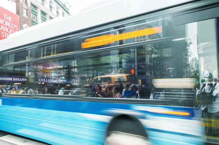 NEW YORK CITY - JUNE 13, 2013: Public us crosses city street. Public bus system is very efficient...