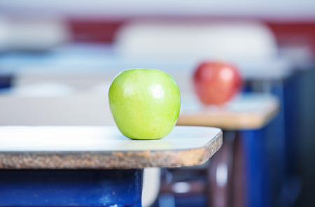 Classroom desks with apples.の写真素材