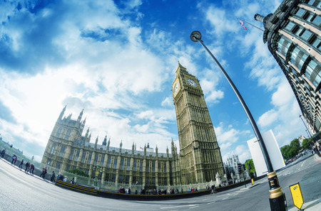 LONDON - SEPTEMBER 28, 2013: Tourists walk under Big Ben. More than 30 million people visit the city...