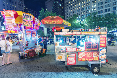 NEW YORK CITY - JUNE 12, 2013: New York street seller in a Manhattan square at night. Food sellers are all over Manhattan offering a variety of street foods.のeditorial素材
