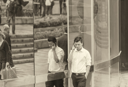 HONG KONG - MAY 7, 2014: Business man walking along business district. Hong Kong is a world favourite business destination.のeditorial素材