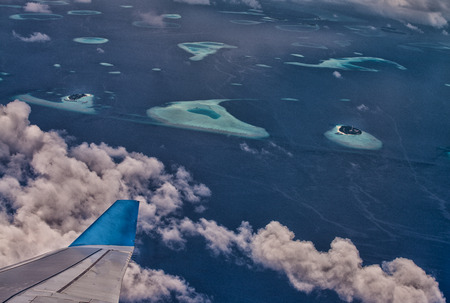 Airplane wing over beautiful Maldives.の写真素材