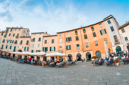 LUCCA, ITALY - APRIL 18, 2015: Tourists and locals in Piazza Anfiteatro. Lucca is one of the most visited town of Tuscany.のeditorial素材