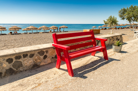 Red bench along the beach.