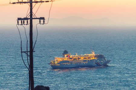 Cruise ship leaving island.の写真素材