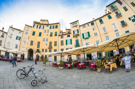 LUCCA, ITALY - APRIL 18, 2015: Tourists and locals in Piazza Anfiteatro. Lucca is one of the most visited town of Tuscany.のeditorial素材