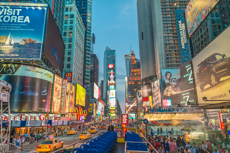 NEW YORK CITY - JUNE 15, 2013: Tourists walk along city streets. New York attracts more than 50...