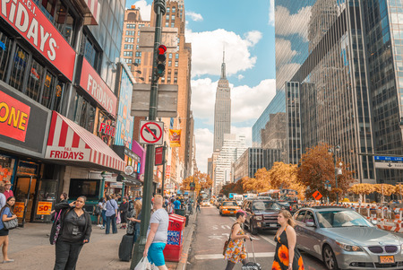 NEW YORK CITY - JUNE 15, 2013: Tourists walk along city streets. New York attracts more than 50 million people annually.のeditorial素材