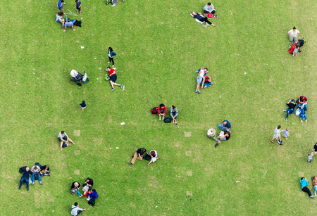 Ninety degrees view of people relaxing on a meadow.の写真素材