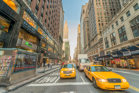 NEW YORK CITY - JUNE 8, 2013: Taxi speeds up along city street. New York has more than 13,000 yellow...