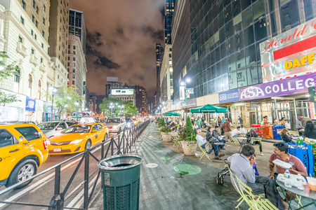 NEW YORK CITY - JUNE 8, 2013: Taxi speeds up along city street. New York has more than 13,000 yellow...