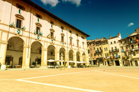AREZZO, ITALY - MAY 12, 2015: Tourists enjoy Piazza Grande on a beautiful day. Arezzo is a very famous tuscan medieval city.のeditorial素材