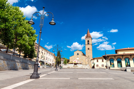 AREZZO, ITALY - MAY 12, 2015: People walk in Saint Augustin Square. Arezzo is one of the most famous tuscan medieval cities.のeditorial素材