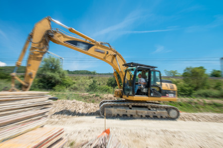Industrial excavator working in a construction site. Blurred motion view.