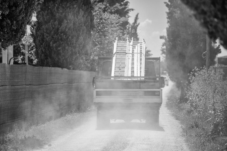 Truck transporting materials on a sandy road.の写真素材