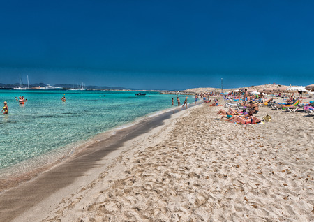FORMENTERA, SPAIN - JUNE 5, 2015: Ses Illetes Beach with tourists. Formentera is a very famous tourist attraction.のeditorial素材