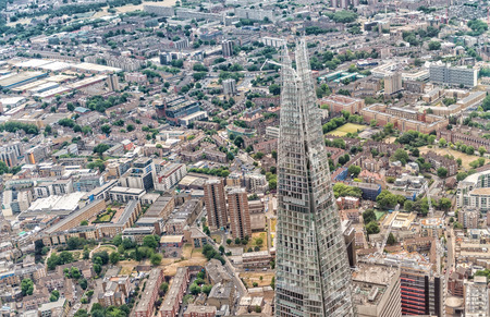 LONDON - JUNE 18, 2015: The Shard and city skyline from helicopter. London attracts 50 million tourists annually.のeditorial素材