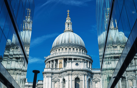 London. St Paul Cathedral reflected in modern glass on a beautiful summer day.の写真素材