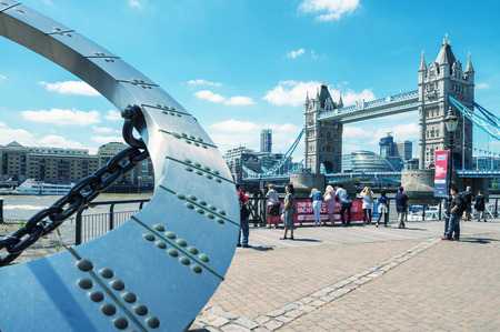 LONDON - JUNE 14, 2015: Tourists near Tower Bridge. London is visited by 50 million people annually.のeditorial素材