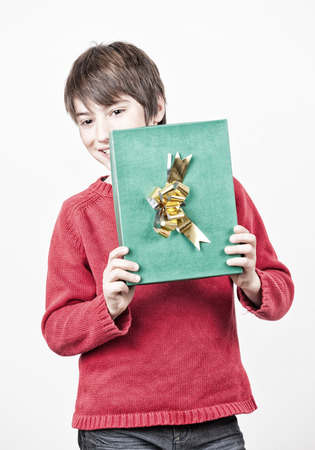 Happy boy before opening Christmas gift.の写真素材