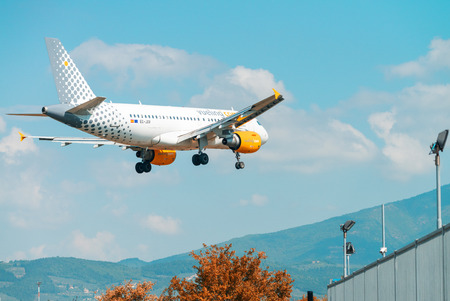 FLORENCE - SEPTEMBER 2, 2015: Vueling airplane lands in Peretola airport. Vueling is a spanish...