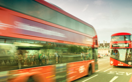 LONDON - JUNE 11, 2015: Red Double Decker Bus along city streets. It is a famous city attraction among tourists.のeditorial素材