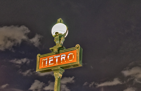 Parisian metro sign Paris France at night.のeditorial素材