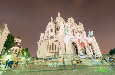PARIS - JUNE 12, 2014: Tourists along Montmartre Hill. Paris is visited by 30 million people annually.のeditorial素材