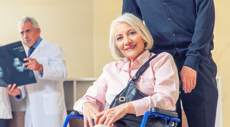 Doctors and patients in hospital room.の写真素材