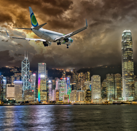 Airplane over Hong Kong skyscrapers.のeditorial素材