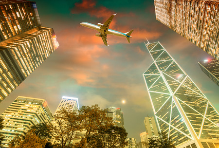 Airplane overflying Hong Kong financial district.のeditorial素材