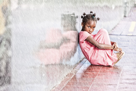 School bullying. Isolated girl under rain.の写真素材
