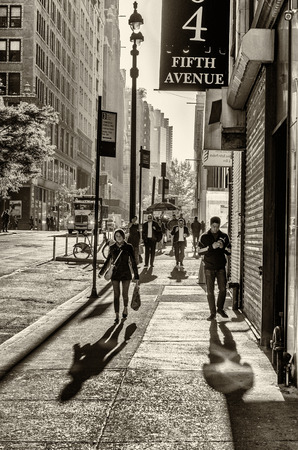 NEW YORK CITY - SEPTEMBER 12, 2015: Tourists and locals along city streets. New York attracts 50 million people worldwide annually.のeditorial素材