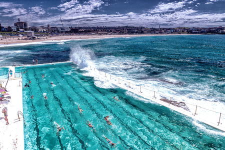 BONDI - OCTOBER 12, 2015: People enjoy the beach on a beautiful sunny day. Bondi Beach is a major...