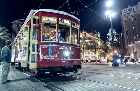 NEW ORLEANS - FEB 11: People travel with the Street car in Canal street at night on February 11, 2016 in New Orleans, USA. It is the oldest continually operating street car line in the world.のeditorial素材