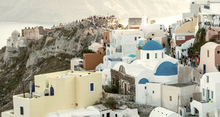 OIA, GREECE - MAY 12, 2014: Tourists await the famous sunset in Santorini. The island a a famous summer tourist destination.のeditorial素材