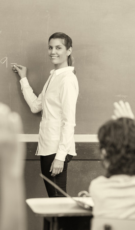 Happy teacher with multi ethnic classroom at school.の写真素材