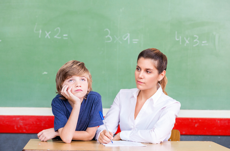 Happy teacher with multi ethnic classroom at school.の写真素材