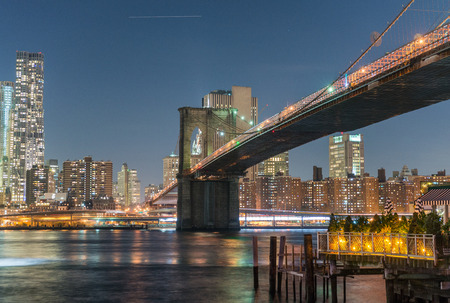 Brooklyn Bridge at twilight with downtown Manhattan.の写真素材