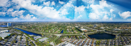 Panoramic aerial view of mall parking area at dusk.