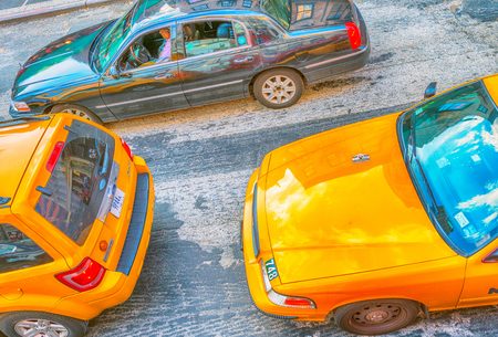 NEW YORK CITY - JUNE 2013: Yellow cabs speed up along city streets. There are more than 10000 taxis in New York.のeditorial素材