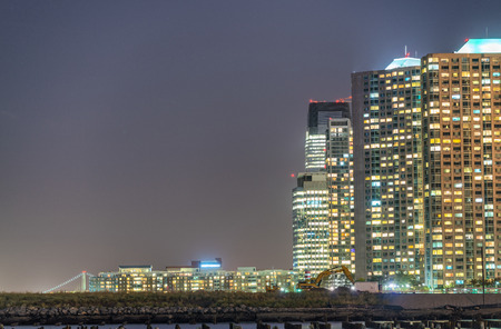 Night view of Jersey City skyscrapers along Hudson river.の写真素材