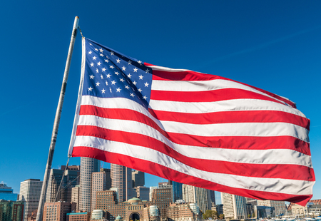 American flag covering Boston skyline, MA - USA.の写真素材