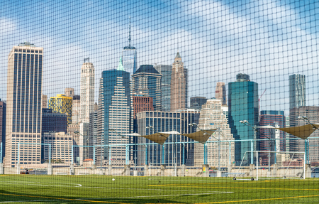 Downtown Manhattan skyline from Brooklyn Bridge Park as seen through field net.の写真素材