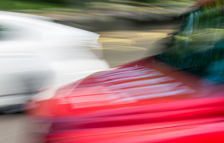 Blurred view of fast moving red taxi in London.の写真素材
