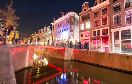 AMSTERDAM - MAY 1, 2013: City canals at night for Queen's Day. Amsterdam attracts 10 million visitors every year.のeditorial素材