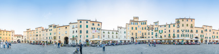 LUCCA. ITALY - OCTOBER 3, 2015: Tourists in Piazza Anfiteatro. Lucca attracts 1 million people every...
