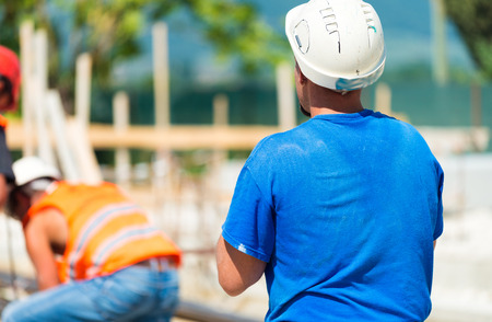 Workers operating in contruction building site.