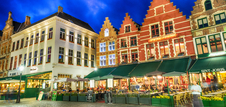 BRUGES, BELGIUM - MARCH 2015: Tourists visit ancient medieval city at night. Brugge attracts more than 2 million people annually.のeditorial素材
