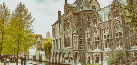 BRUGES, BELGIUM - MARCH 2015: Tourists visit ancient medieval city on a cloudy day. Brugge attracts more than 2 million people annually.のeditorial素材